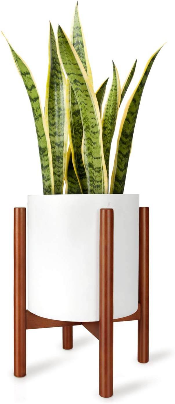A planter with a white pot and wood holder.