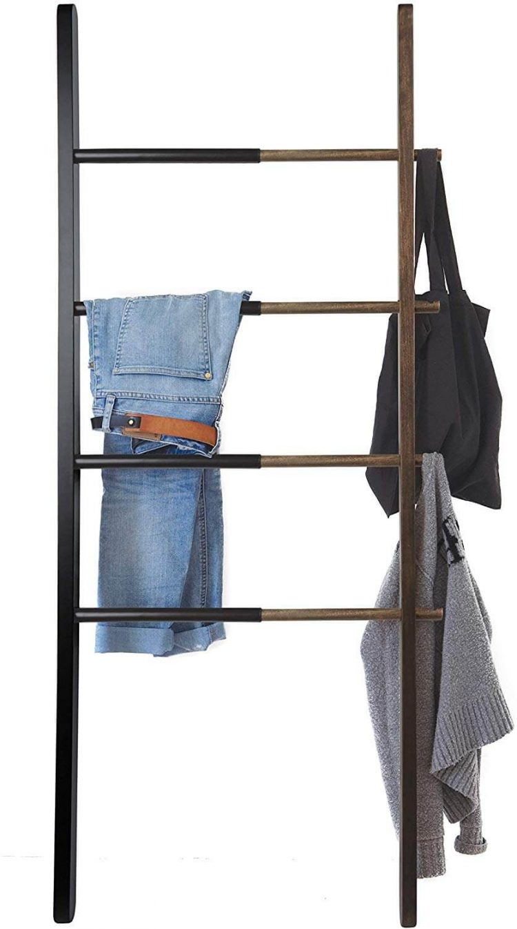 Bed and bath ladder with clothes draped over the rungs.