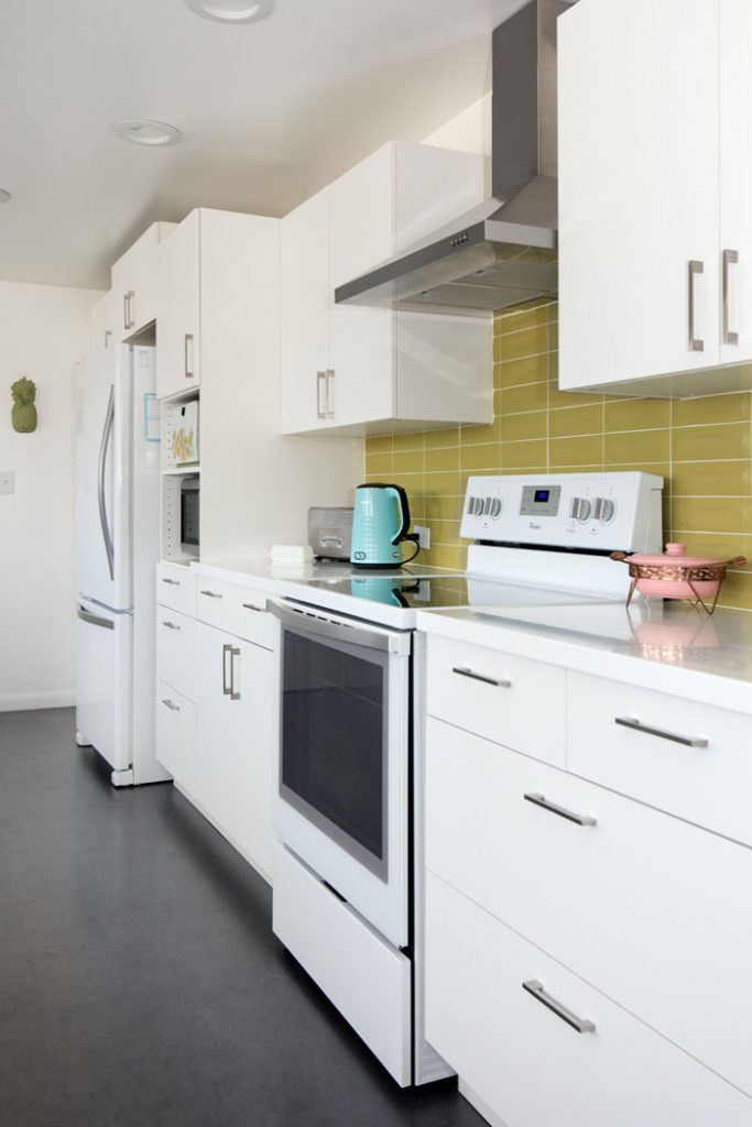 Mod green and white kitchen with black floors