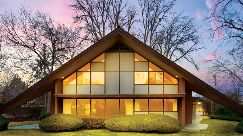 Mid Century Modern home with illuminated windows