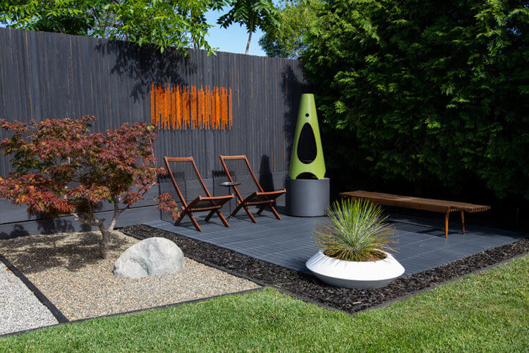 A green outdoor fireplace on a dark patio. mid century modern fireplaces