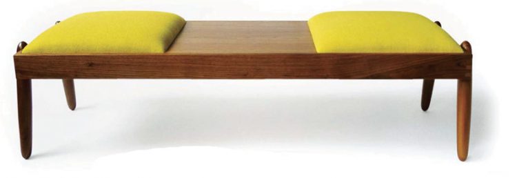 A mid century bench with a polished-wood exterior and two yellow cushions on each side.
