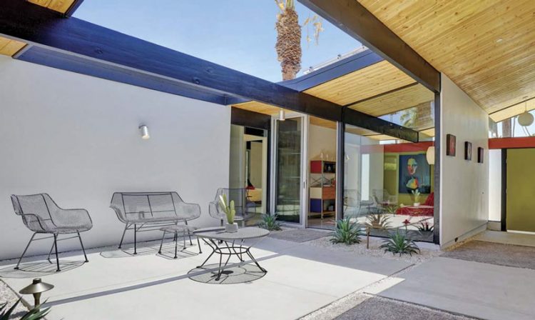 A mid century backyard featuring an open atrium and geometrically placed plants.