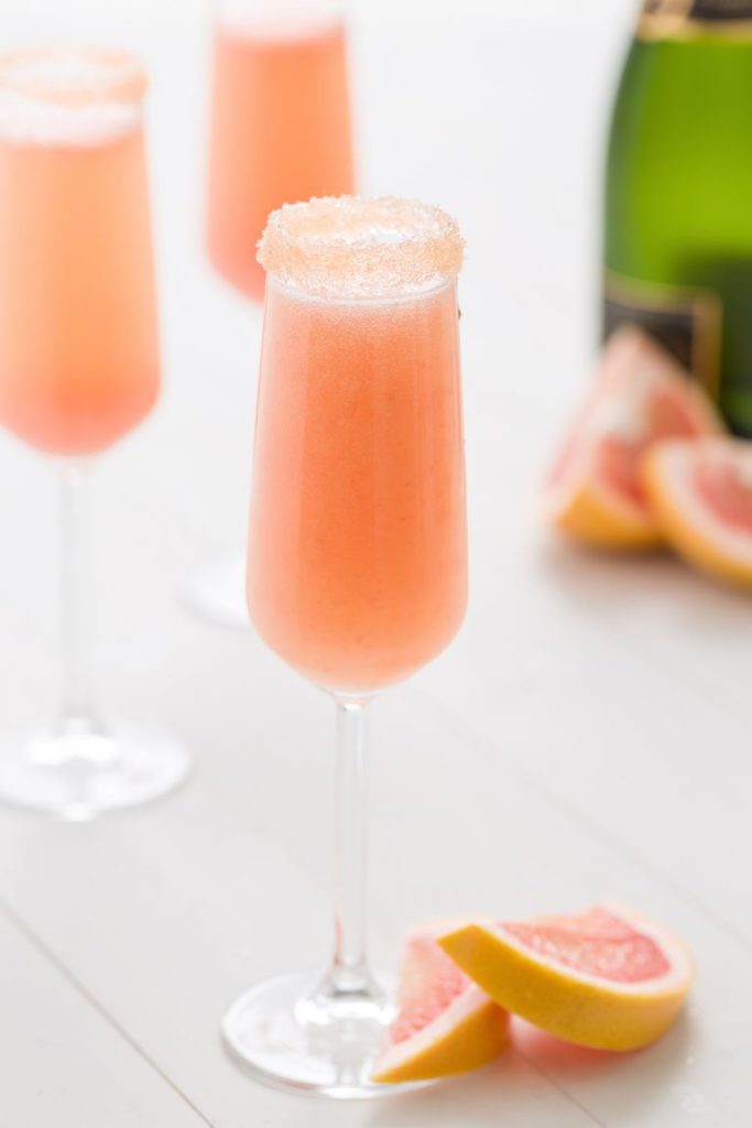 Grapefruit mimosa in tall clear glass with guar on rim