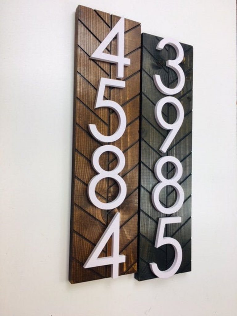 white house numbers mounted on wood plaques perfect for a mid century modern patio