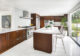 Midcentury Modern kitchen with dark wood cabinetry and white countertops