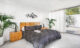 Midcentury Modern bedroom with a genuine brick accent wall in white