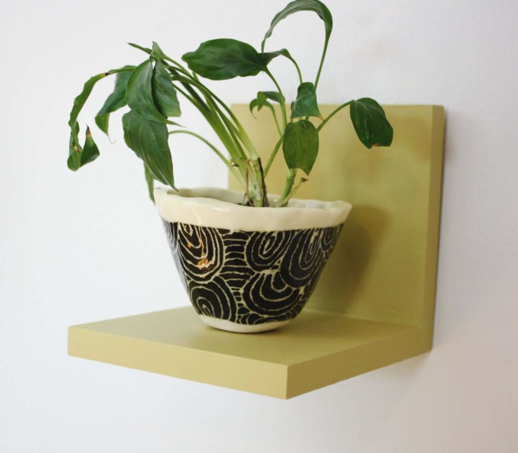 Small green shelf that can act as a tiny nightstand