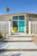 turquoise door and breeze block fence MCM exterior