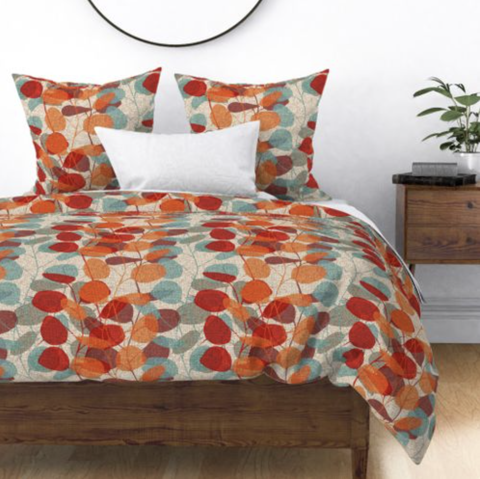 MCM fall bedding with blue, orange and red leaf pattern