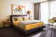 modern master bedroom yellow and gray bedding
