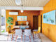 Eichler Orange dining room with palm tree wall decor