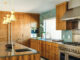 Palm Springs kitchen with teak cabinets and teal tile backsplash