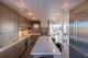 A kitchen with a quartz countertop and brass fixtures