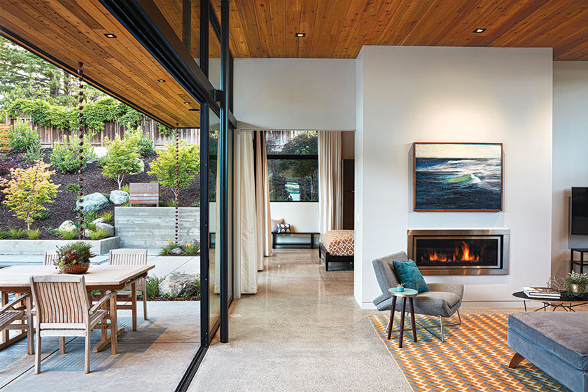 open living room and patio with fireplace and linear design