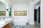 Mid-century design bathroom with square tub and modern art