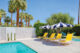 backyard Twin Palms neighborhood Palm Springs pool striped umbrellas