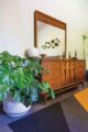 monstera plant in mid century modern bedroom