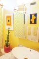 Bathroom with yellow walls and Mid Century Modern accents
