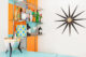 MCM bar setup with starburst clock and orange and teal checkered wall