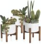 3 white planters with wooden legs.