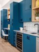 dark blue cabinets wine fridge and desk in Project House Austin