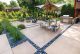 paved dining area and fire pit in Wisconsin modern backyard