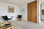 Sitting room in mid century home with leather chairs and natural wood details