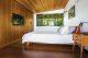 bedroom with wood ceiling, wall and platform bed