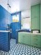 green bathroom cabinetry and blue tile in master bathroom