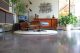 finished concrete flooring and eames lounge chair