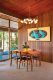 dining area with wood paneled wall in California Modern house