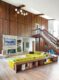 wood panels and lime green sectional and Egg chair in vibrant Michigan home