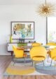 yellow Saarinen dining chairs in vibrant Michigan home MCM credenza