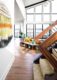 wall hanging wooden staircase and wall of windows in Michigan home