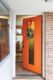 MCM holiday home in Boise wreath on orange door