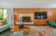 original poured terrazzo fireplace and wood paneling in restored Old Las Palmas home