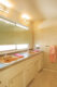 retro pink sinks and Formica countertops in primary bathroom of restored Old Las Palmas home