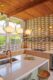 brass finishes and tile walls in remodeled kitchen