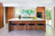 A large island and four barstools in a mid century modern kitchen