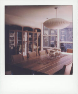 rectangular table surrounded by chairs in adrian pearsall's dining room