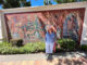 Cati Porter standing in front of Brad Keeler's ceramics mural
