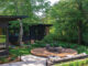 Milwaukee mid century modern landscape with elevated fire pit and black Acapulco chairs