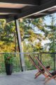 deck with overhanging roof and modern lounge chairs