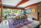 dining room with white porcelain tile floor exposed beam ceiling and concrete block walls