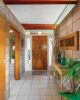 entryway with wood door wooden beams and concrete block wall