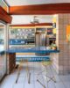 MCM kitchen with blue tile backsplash and countertop