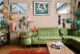 Lisa Rathbone's mid century living room with green sectional and tiki style lamps