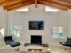 Ralph Haver home living room with exposed beam ceiling and view to pool