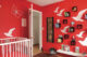 red nursery with white dove decal and black square shelves